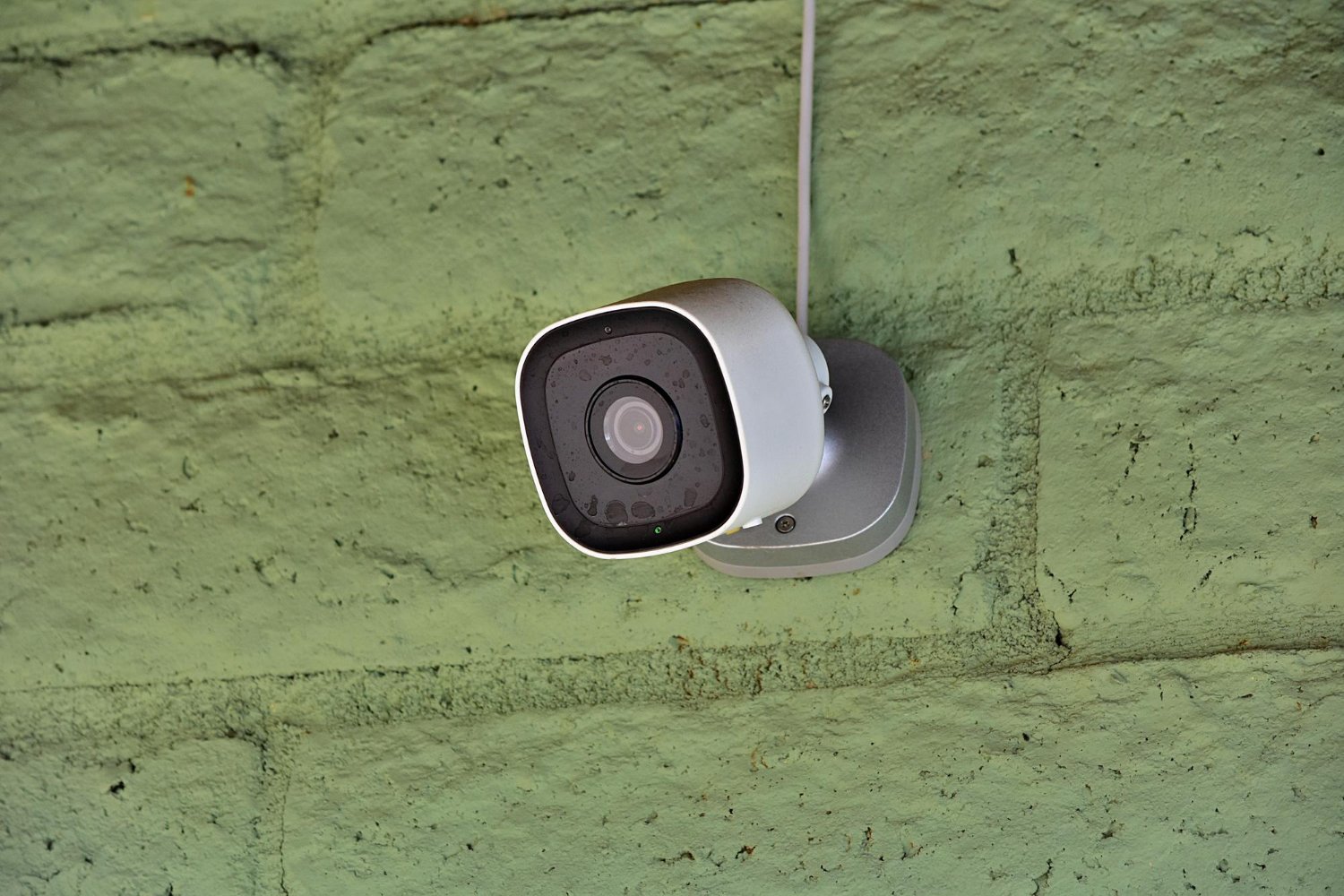 Wired security camera in Albuquerque with PoE cable mounted on exterior wall for business surveillance