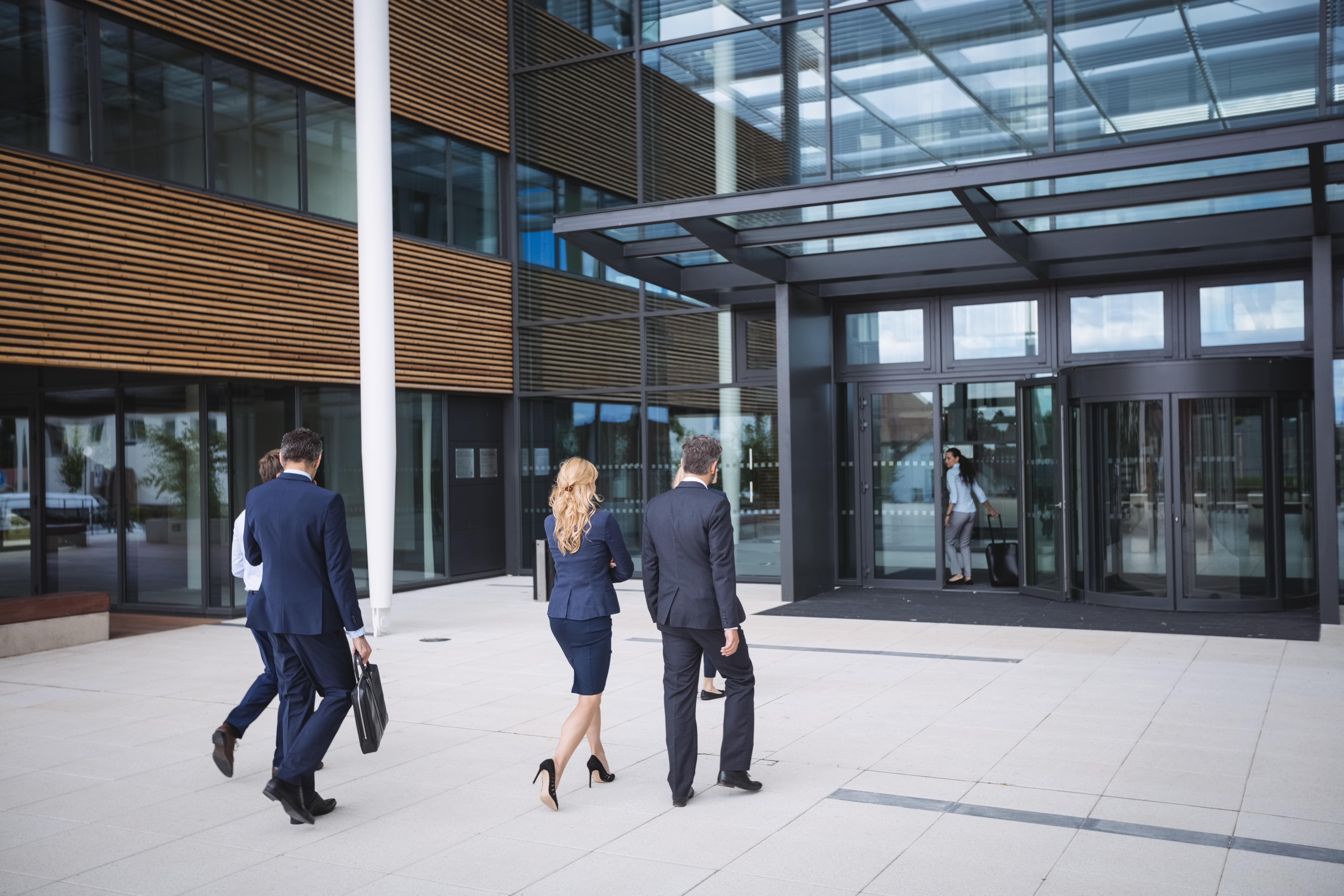 security assessment team approaching commercial building entrance for walkthrough