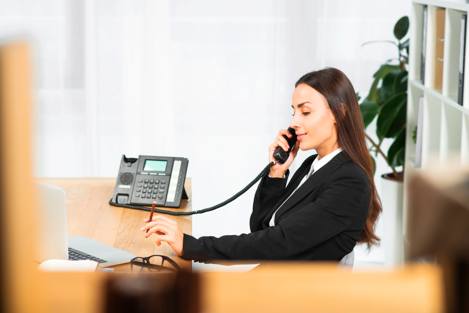 Woman on phone after New Mexico office phone system installation