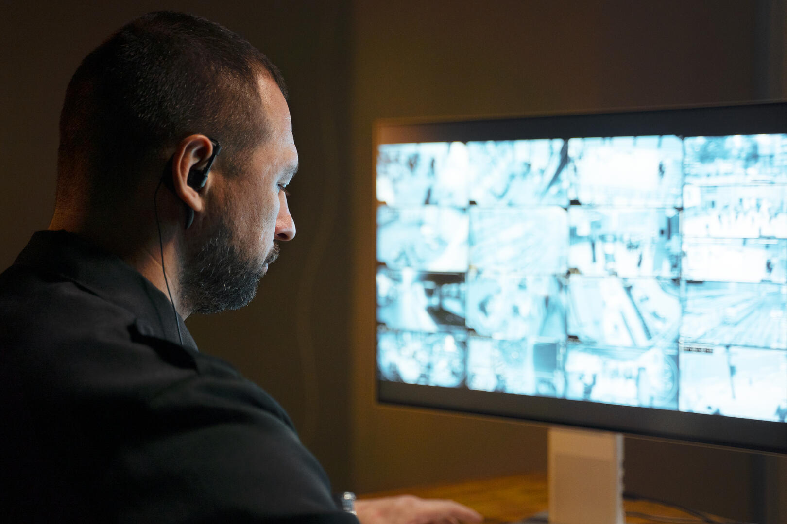 security professional monitoring commercial surveillance camera system